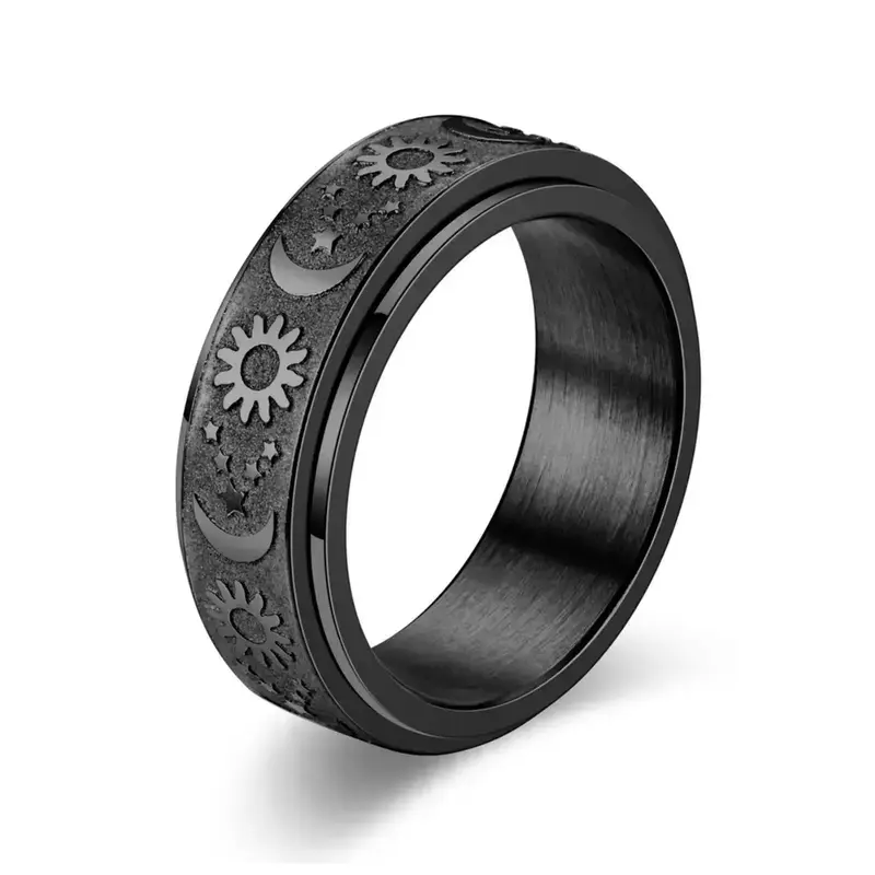 Black sun and moon spinner band ring with embossed celestial relief on white background