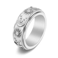 Silver sun and moon spinner band ring with embossed celestial relief on white background